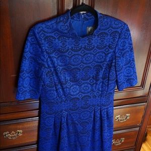 A blue dress covered in a lace-like material